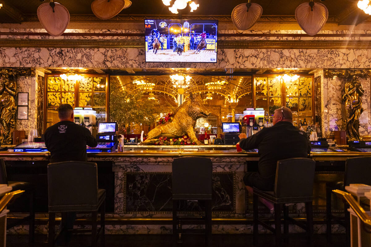 People drink at a bar at Main Street Station, which is adorned with vintage relics across the p ...