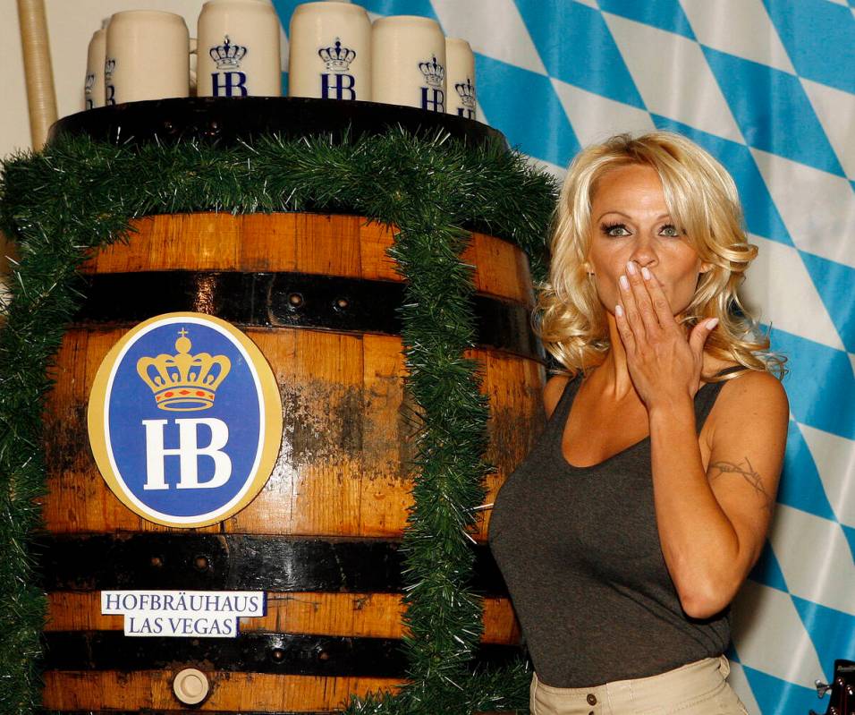 Pamela Anderson taps a keg to celebrate Oktoberfest at the Hofbrauhaus restaurant in Las Vegas ...