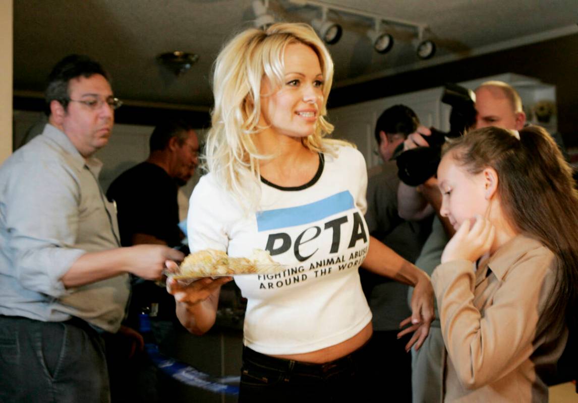 Actress Pamela Anderson serves vegetarian Thanksgiving dinners to needy families during a visit ...