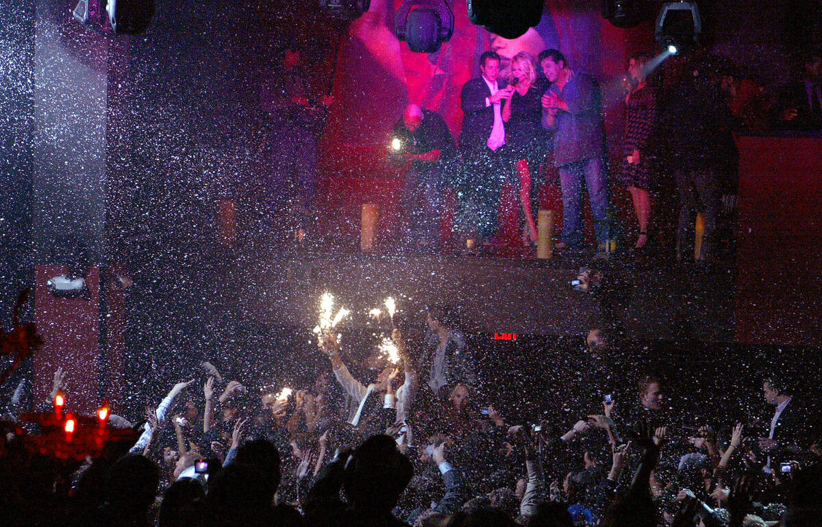 Pamela Anderson rings in the New Year at midnight as confetti rains down on revelers Monday, Ja ...