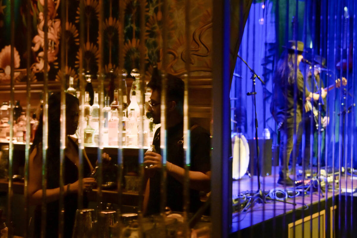 Bartenders and musicians are reflected in mirrors at Caspian’s at Caesars Palace Tuesday ...