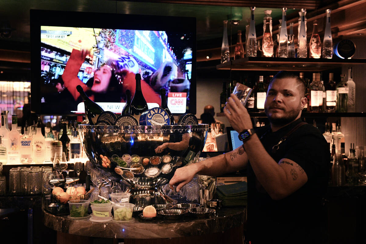 A bartender checks a glass in front of a caviar display at Caspian’s at Caesars Palace T ...