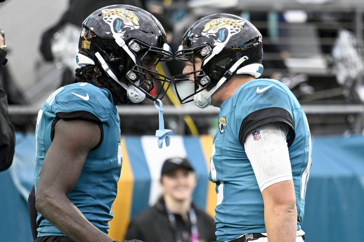 Jacksonville Jaguars wide receiver Brian Thomas Jr., left, and Jacksonville Jaguars quarterback ...