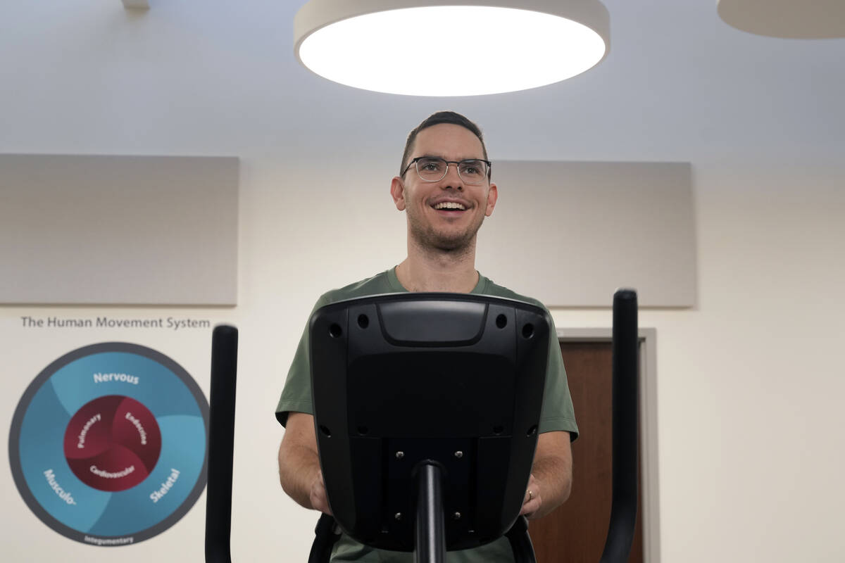 Jacob Bullard warms up on an elliptical machine while undergoing physical therapy at WashU, Mon ...