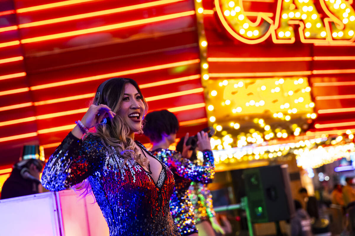 A dancer performs at a silent disco party during the New Year's Eve celebration at the Fremont ...