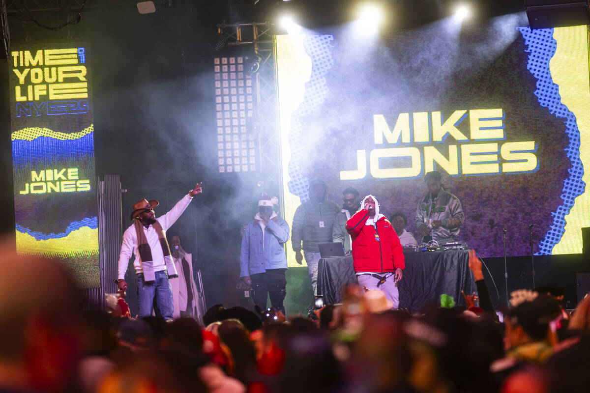 Mike Jones, right, performs at the Fremont Street Experience during the New Year’s Eve c ...