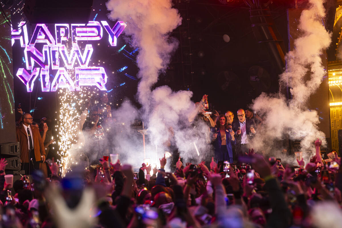 Las Vegas Mayor Shelley Berkley, center right, rings in the New Year on stage with Flo Rida and ...