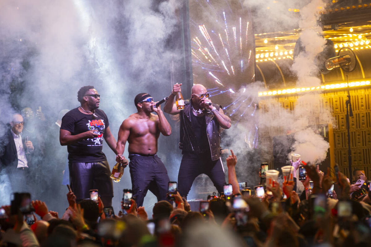 Flo Rida, right, rings in the New Year on stage during the New Year's Eve celebration at the Fr ...