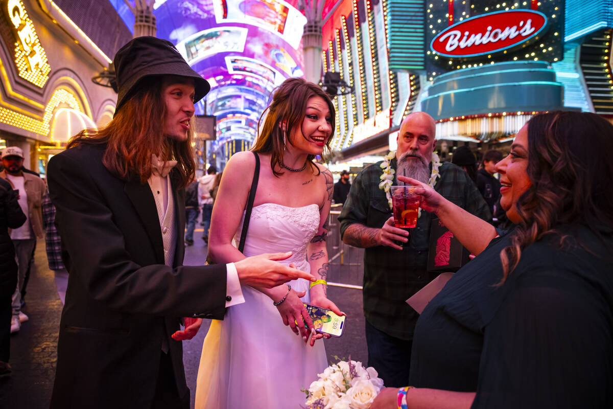 Newlyweds Drew and Lexi Eslinger, of Las Vegas, greet fellow newlyweds Josh Leslie and Myla May ...