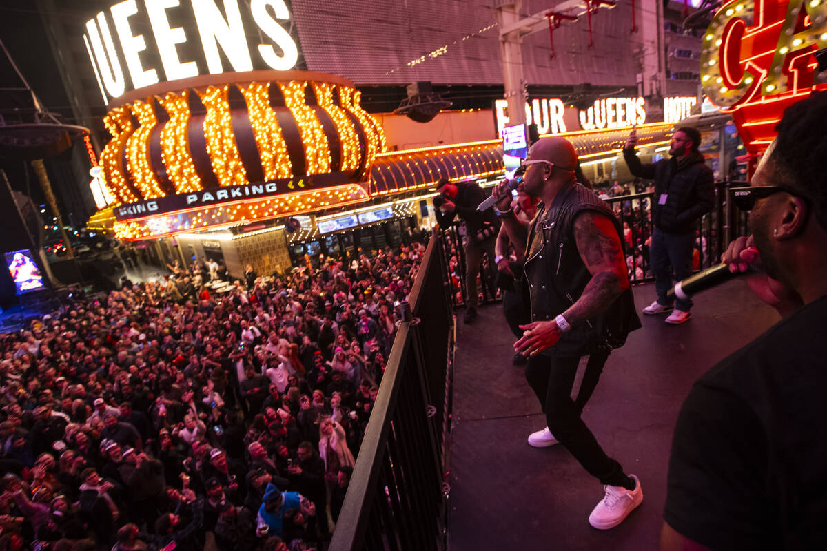 Flo Rida performs from a camera riser during the New Year's Eve celebration at the Fremont Stre ...