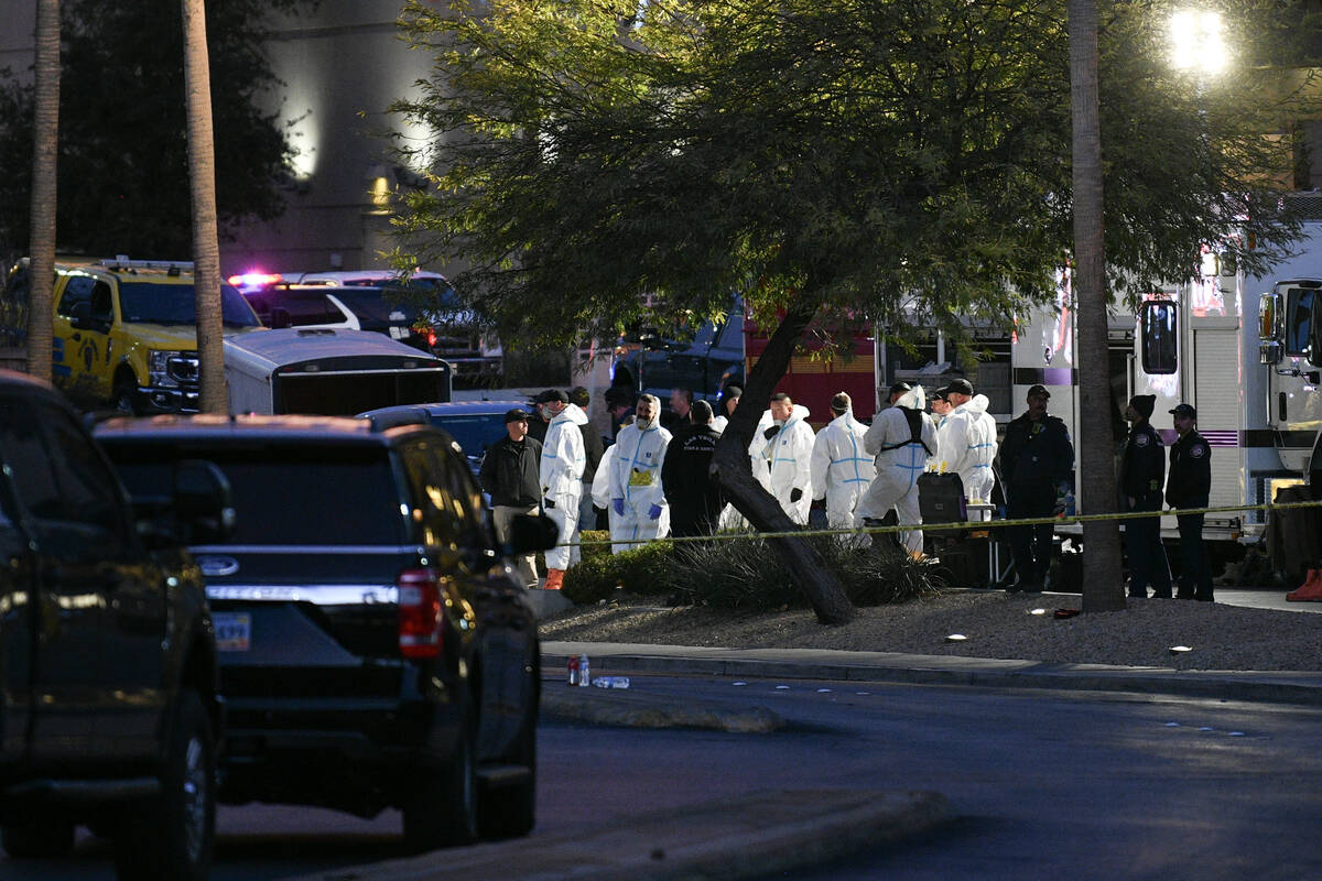 Workers in hazmat suits are seen outside Trump International Hotel in Las Vegas after a Tesla C ...