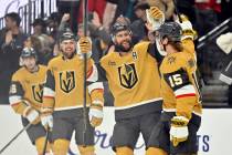 Vegas Golden Knights defenseman Alex Pietrangelo, second right, congratulates Noah Hanifin (15) ...