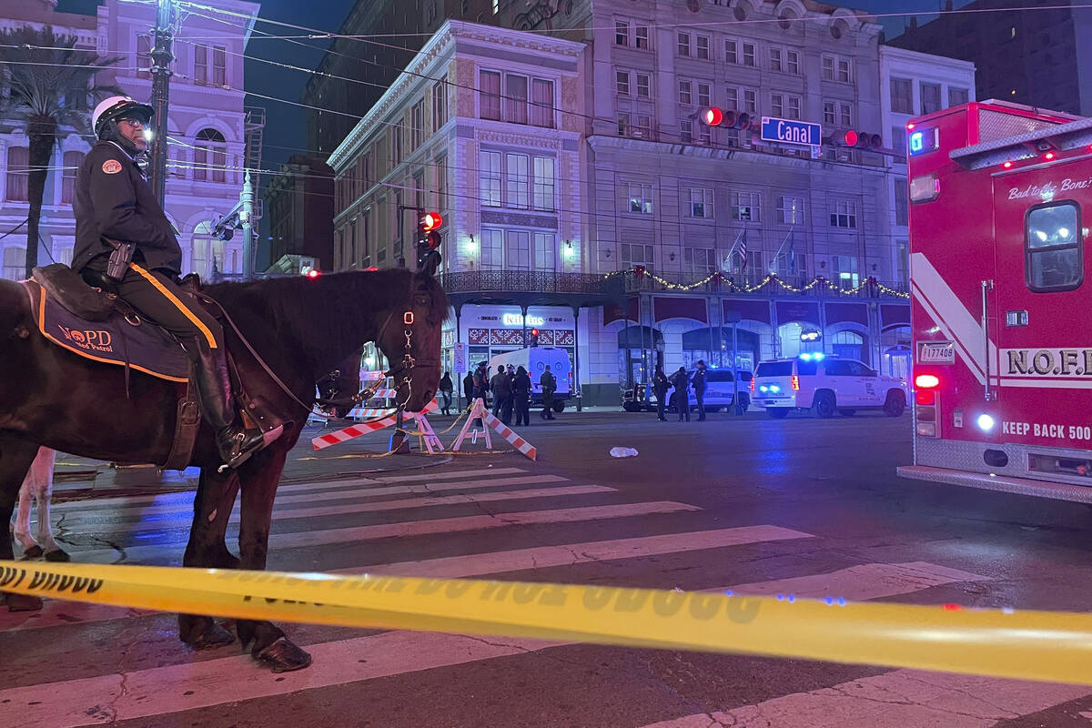 A mounted police officer arrives on Canal Street after a vehicle drove into a crowd earlier in ...