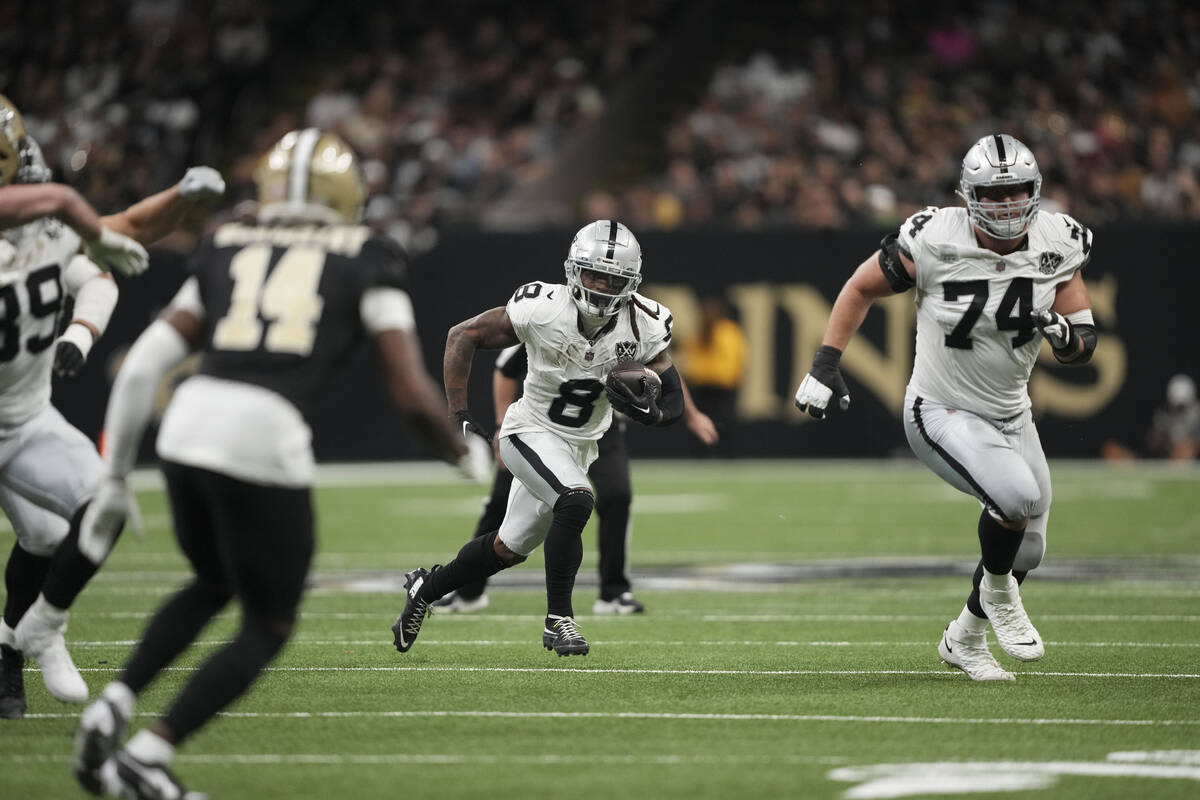 Las Vegas Raiders running back Ameer Abdullah (8) carries behind offensive tackle Kolton Miller ...