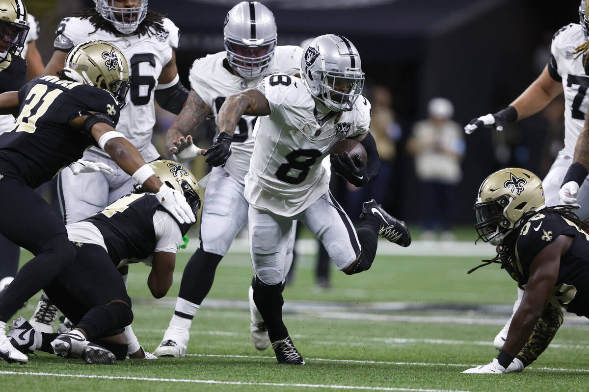 Las Vegas Raiders running back Ameer Abdullah (8) runs from New Orleans Saints defenders during ...