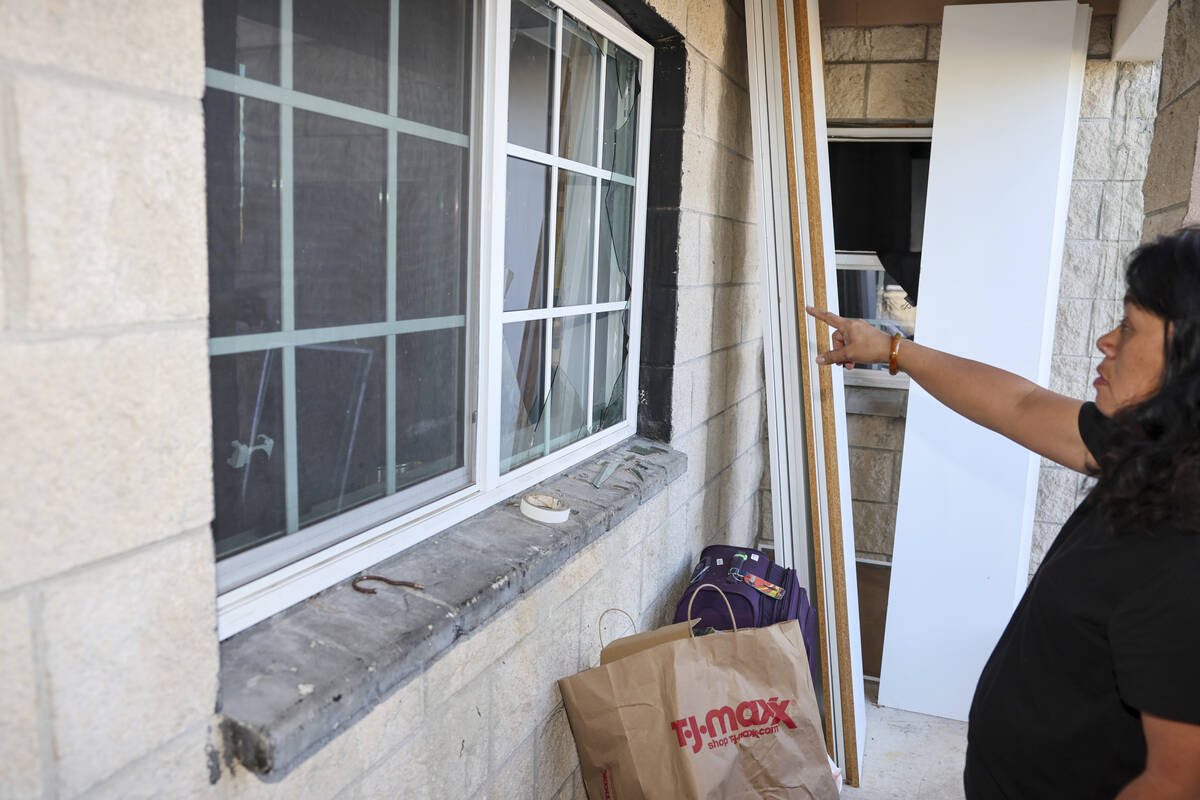 Evelyn Paguirigan points to broken windows at her home across the street from where a New Year' ...