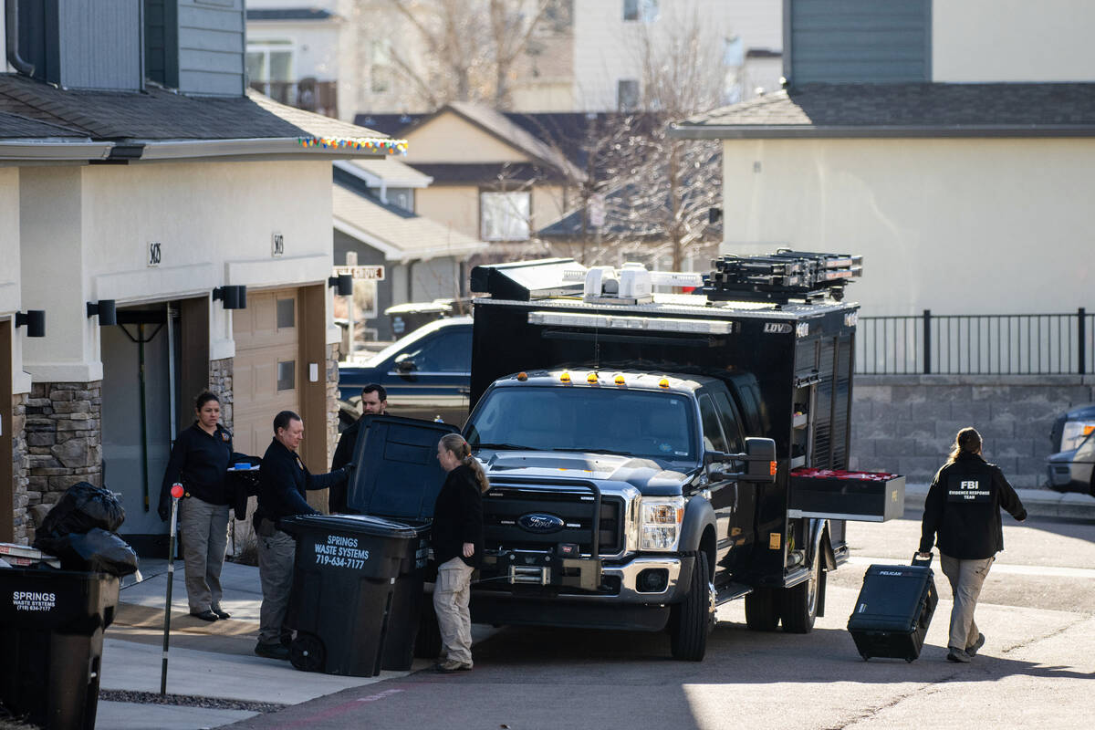 Investigators search a townhouse in northeastern Colorado Springs, Colo., Thursday, Jan. 2, 202 ...