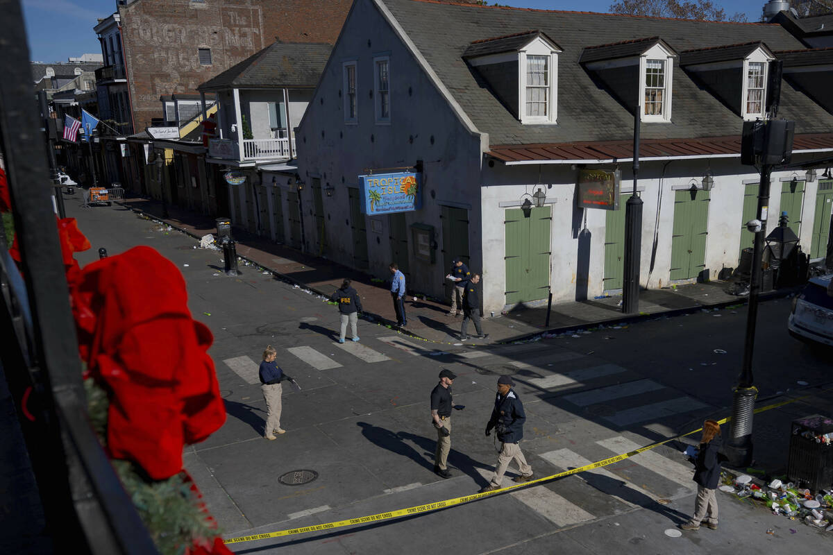 Members of the FBI walk around Bourbon Street during the investigation of a truck fatally crash ...