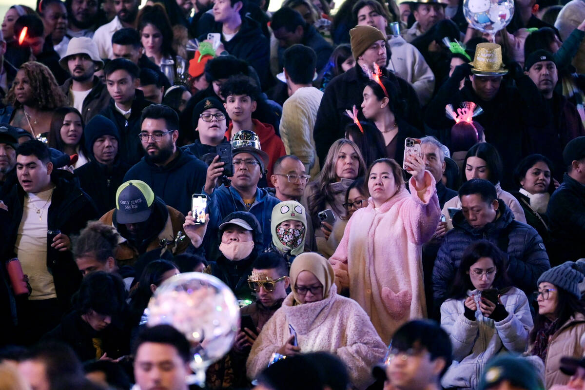 Crowds of people line the Strip to watch New Year's Eve fireworks Tuesday, December 31, 2024, i ...