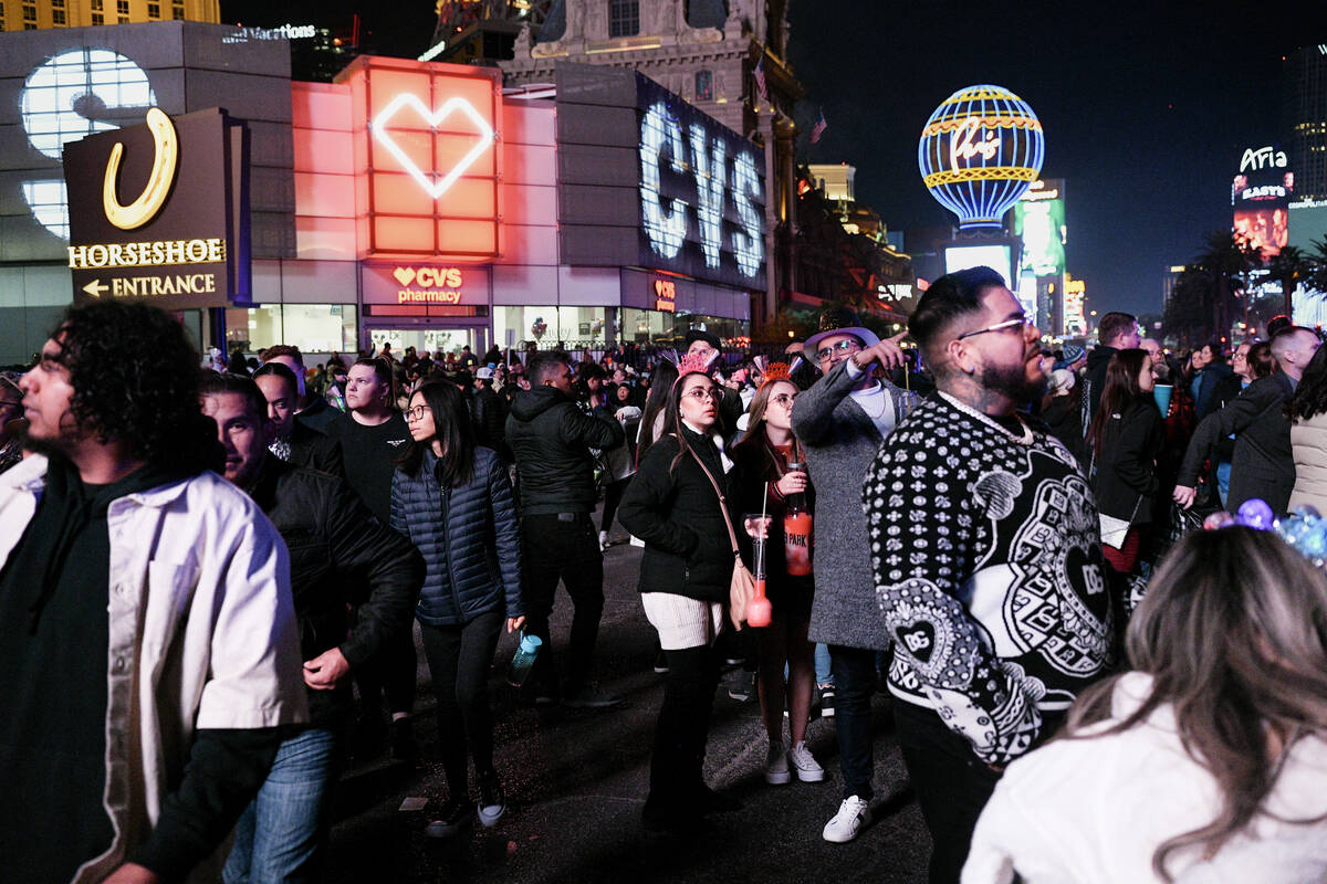 Crowds of people gather on the Strip to celebrate New Year’s Eve Tuesday, December 31, 2 ...