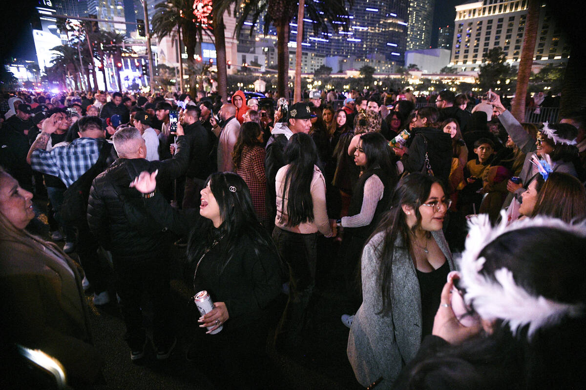 Crowds of people gather on the Strip to celebrate New Year’s Eve Tuesday, December 31, 2 ...