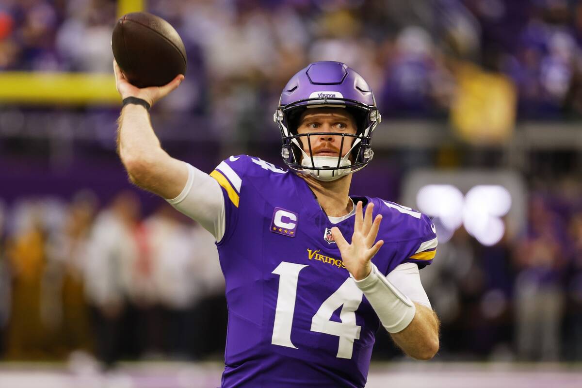 Minnesota Vikings' Sam Darnold warms up before an NFL football game against the Green Bay Packe ...