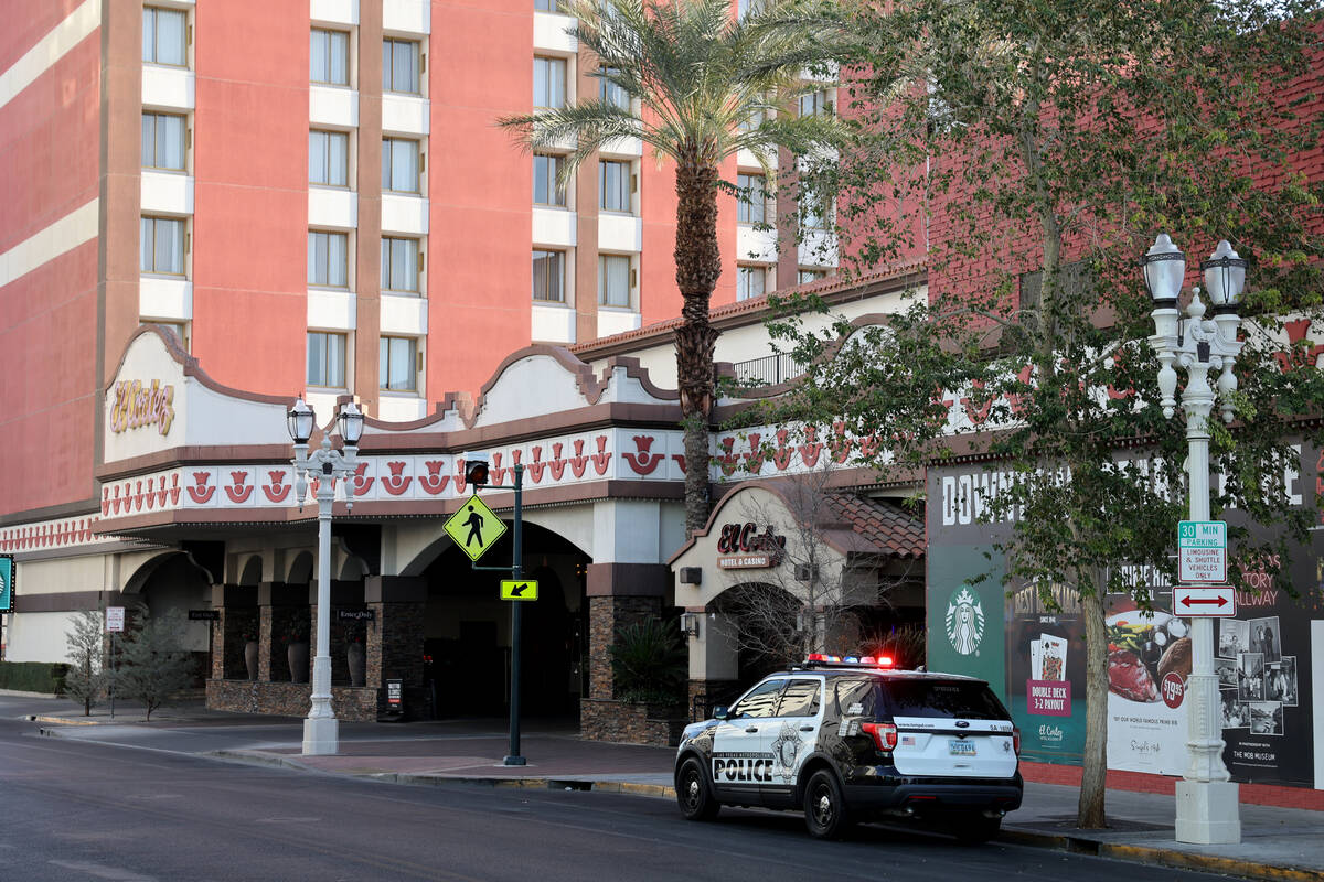 A Las Vegas police vehicle is seen with flashing lights at 6th Street near Ogden Avenue in down ...