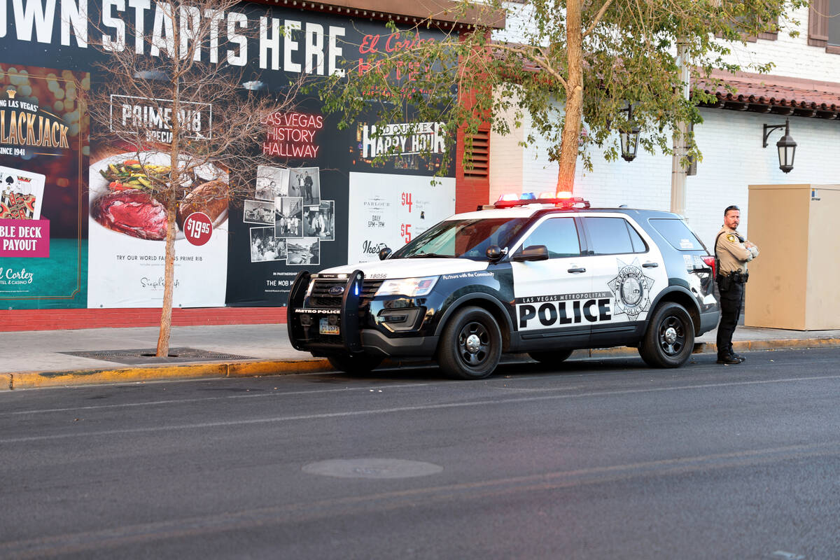 A Las Vegas police vehicle is seen with flashing lights at 6th Street near Ogden Avenue in down ...