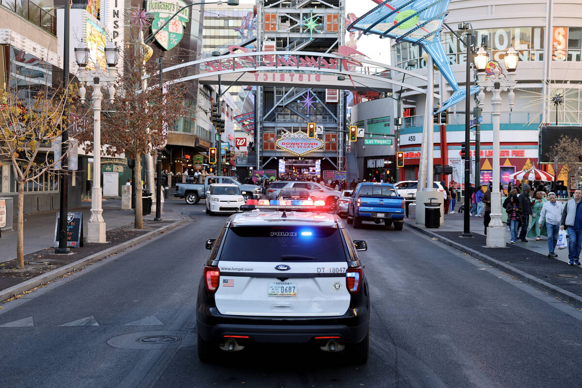 A Las Vegas police vehicle is parked with flashing lights on East Fremont Street near Las Vegas ...