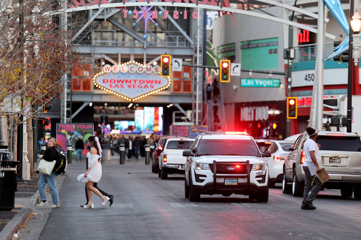 A city of Las Vegas marshal vehicle is parked with flashing lights on East Fremont Street near ...