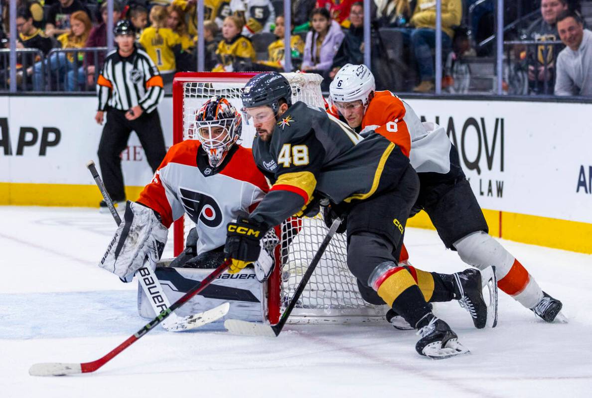 Golden Knights center Tomas Hertl (48) attempts to curve around the net for a shot against Phil ...