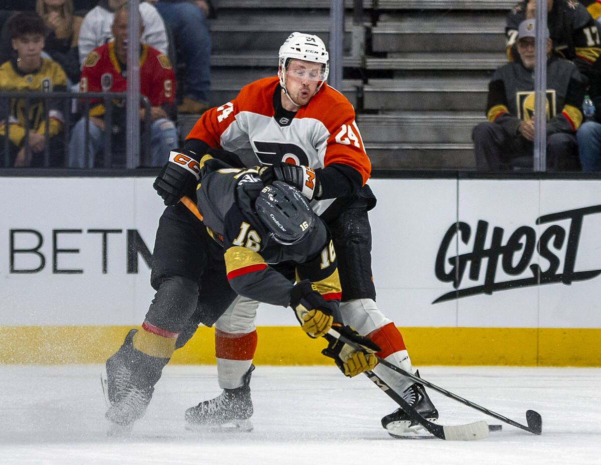 Golden Knights left wing Pavel Dorofeyev (16) is taken to the ice by Philadelphia Flyers defens ...