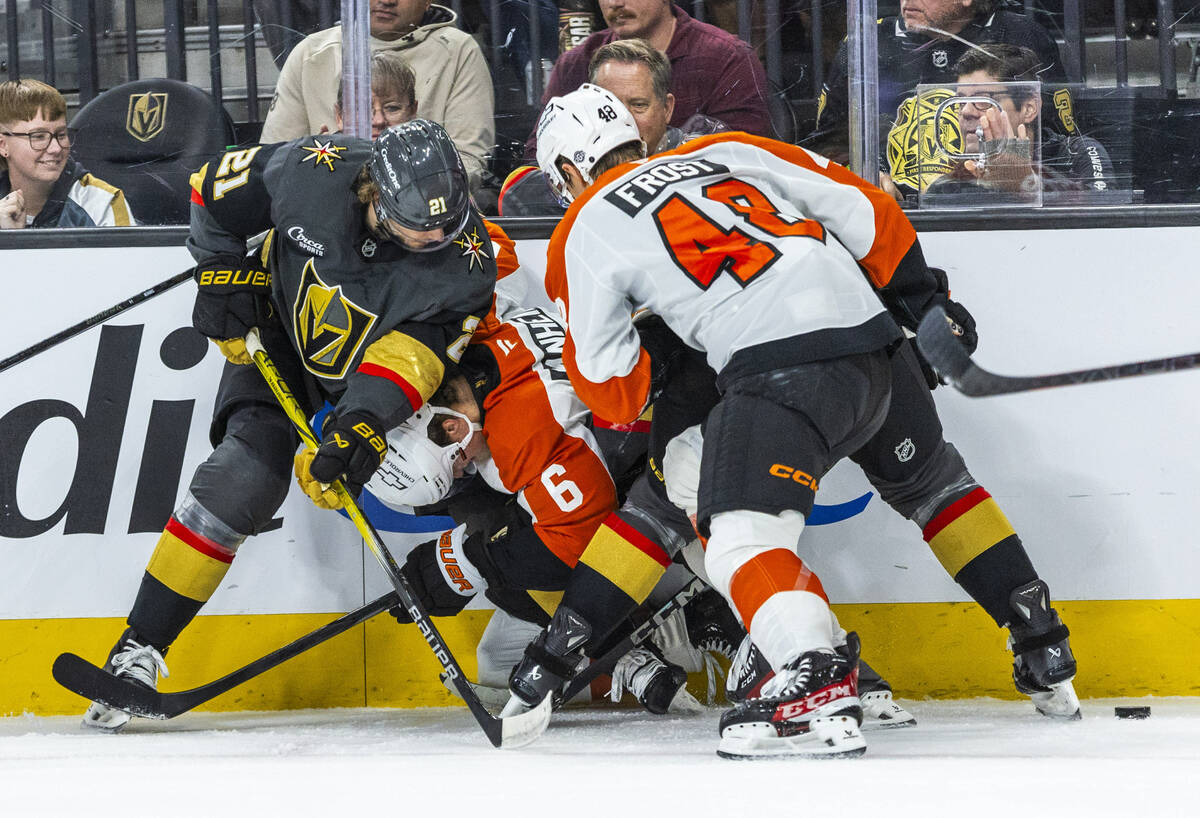 Golden Knights center Brett Howden (21) battles ion the boards for the puck with Philadelphia F ...