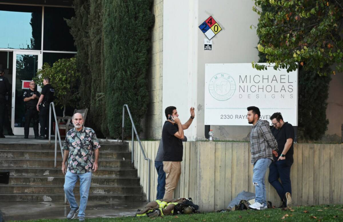 People stand outside of a building where a plane crash occurred Thursday, Jan. 2, 2025, in Full ...