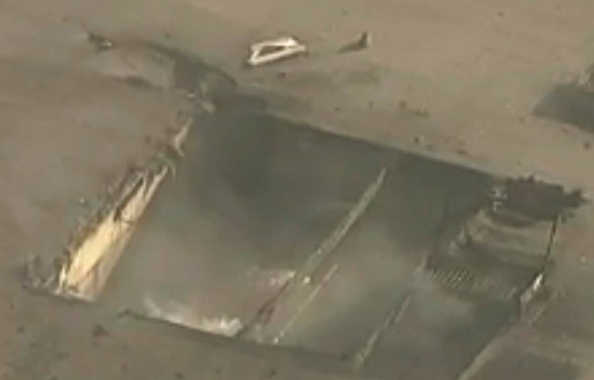 In this image taken from video, shows a gaping hole in a commercial building after a small plan ...