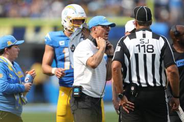 Los Angeles Chargers coach Jim Harbaugh speaks with referees during the second half of an NFL g ...