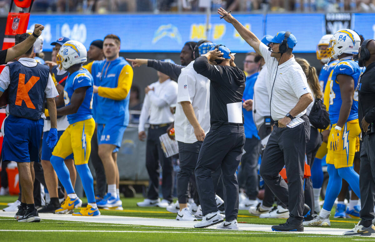 Los Angeles Chargers head coach Jim Harbaugh yells on the sidelines against the Raiders during ...