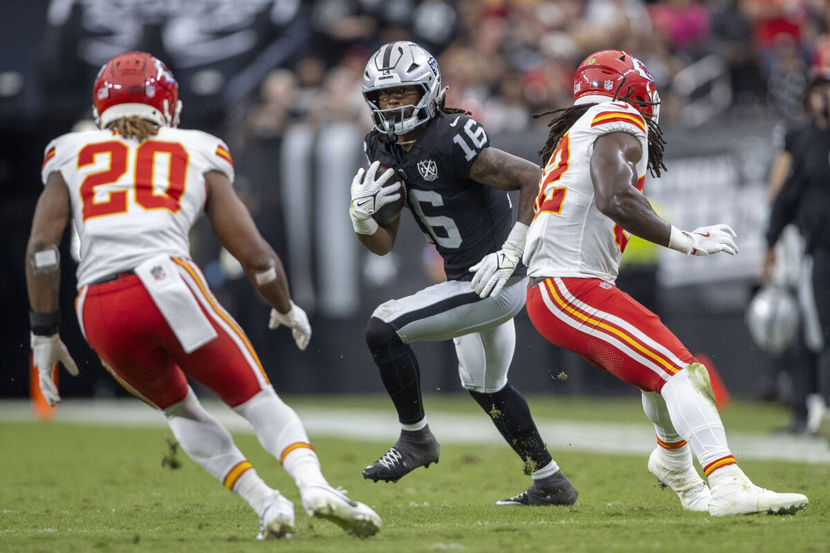 Raiders wide receiver Jakobi Meyers (16) looks to run past Kansas City Chiefs safety Justin Rei ...