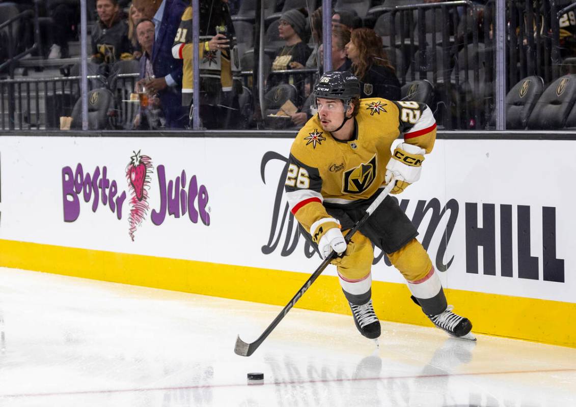 Golden Knights right wing Alexander Holtz (26) controls the puck during the NHL hockey game aga ...