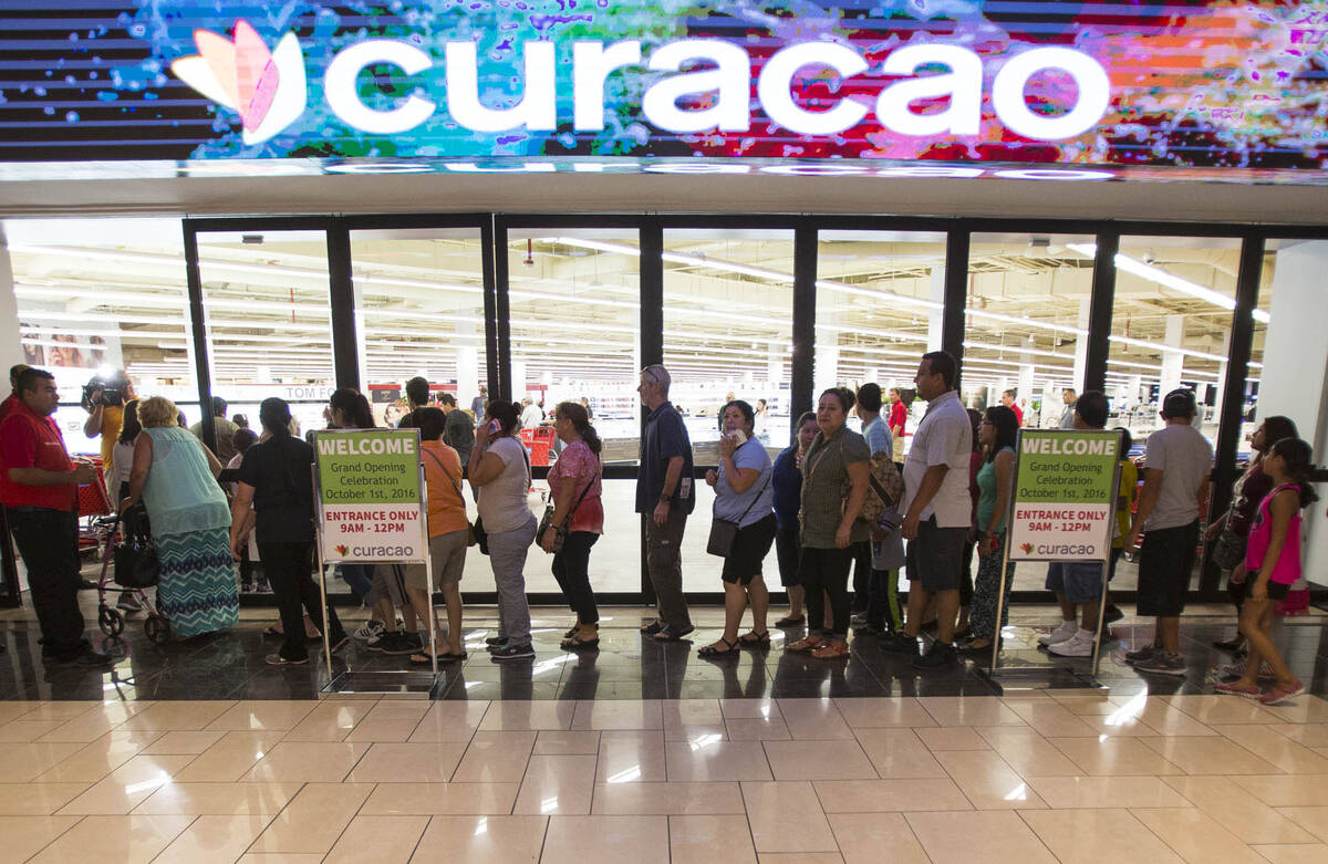 First shoppers are let in at the grand opening of electronics and appliance retailer Curacao at ...