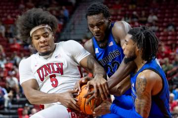 UNLV forward Rob Whaley Jr. (5), Memphis Tigers center Moussa Cisse (32) and Memphis Tigers gua ...