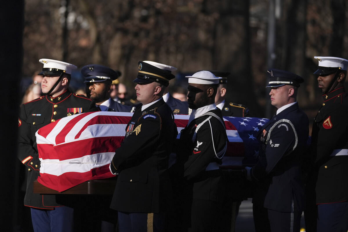 A military body bearer team carries the casket of former President Jimmy Carter into the Jimmy ...