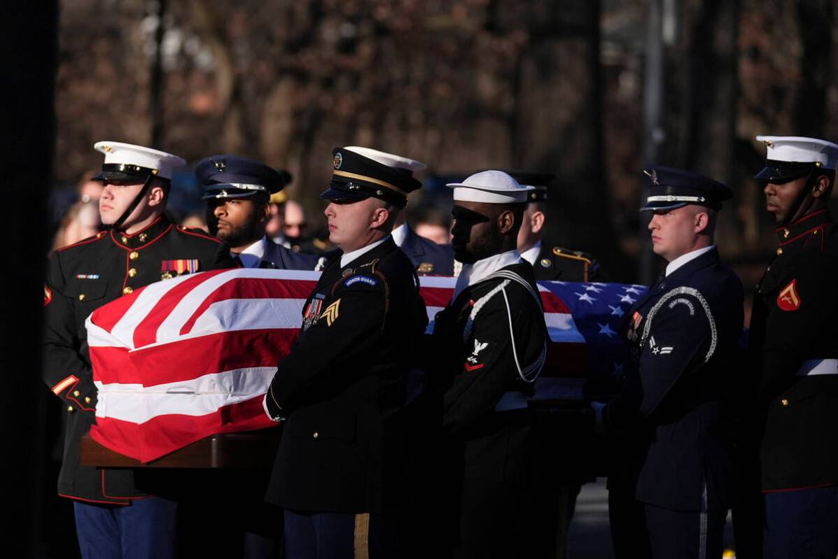 A military body bearer team carries the casket of former President Jimmy Carter into the Jimmy ...