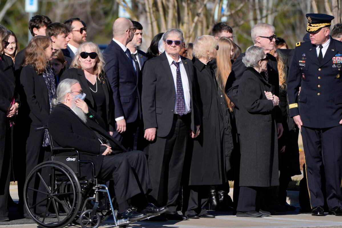 Members of the Carter family wait before the flag-draped casket of former President Jimmy Carte ...