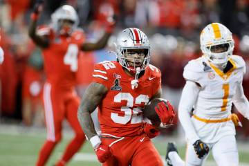 Ohio State running back TreVeyon Henderson, front, scores a touchdown against Tennessee during ...