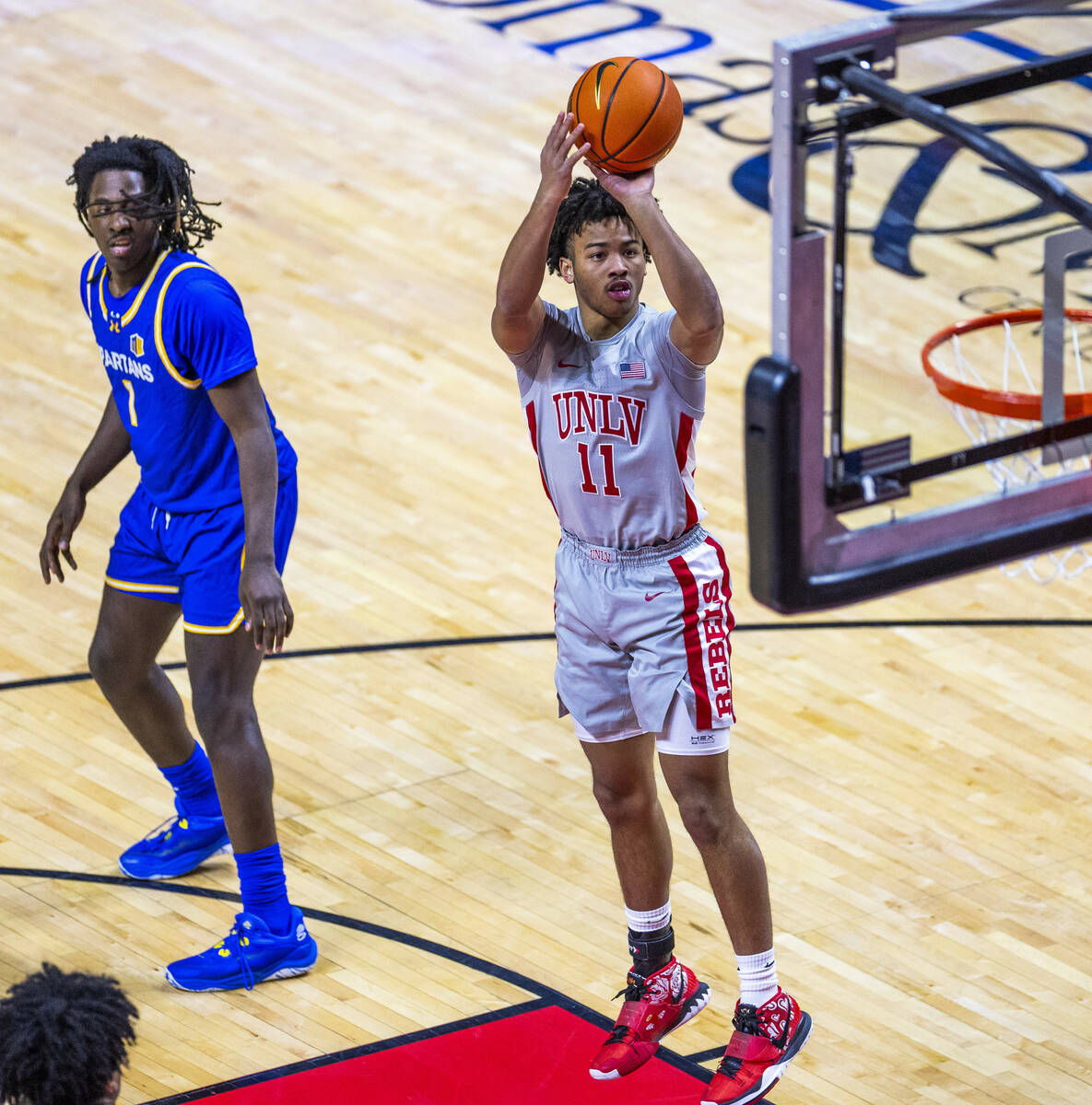 UNLV guard Dedan Thomas Jr. (11) gets off a jump shot past San Jose State Spartans guard Will M ...