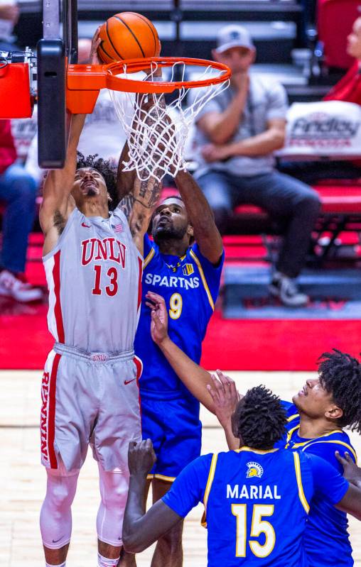 UNLV guard Brooklyn Hicks (13) sets up to score a rebound over San Jose State Spartans guard Jo ...