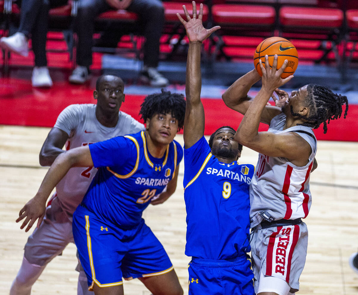 UNLV guard Jaden Henley (10) looks to shoot over San Jose State Spartans guard Josh Uduje (9) d ...