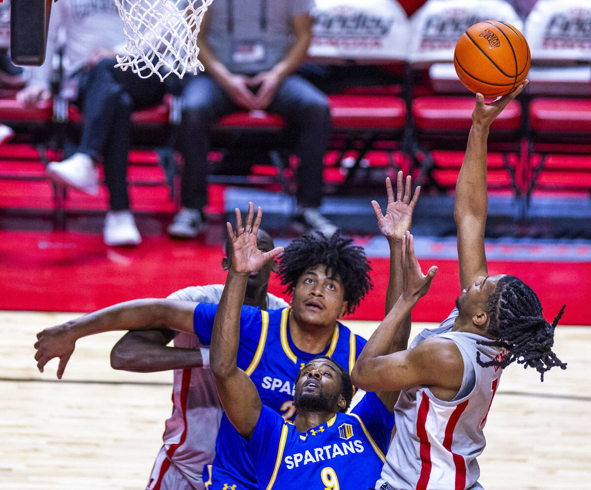 UNLV guard Jaden Henley (10) looks to shoot over San Jose State Spartans guard Josh Uduje (9) d ...