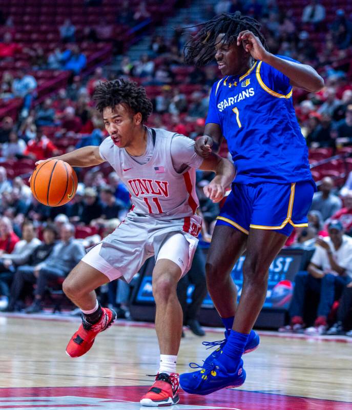 UNLV guard Dedan Thomas Jr. (11) battles in the lane against San Jose State Spartans guard Will ...